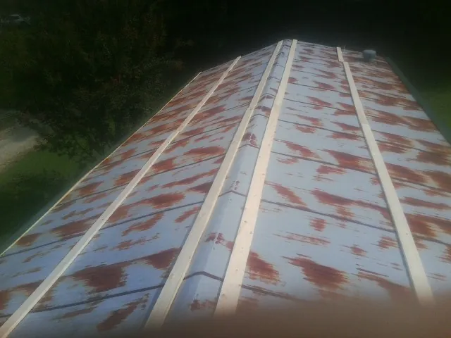 Rusted metal roof panels with new wood purlins before replacement — Storm Damage Roof Repair in Phoenicia by Roofing Brothers