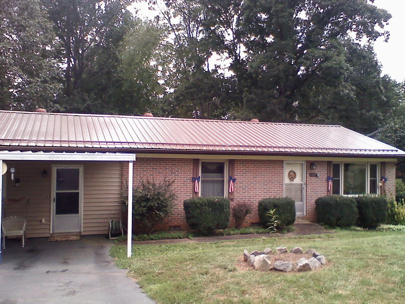 Bronze metal roof and carport on a brick ranch home — Roof Repair work by our crew in Phoenicia