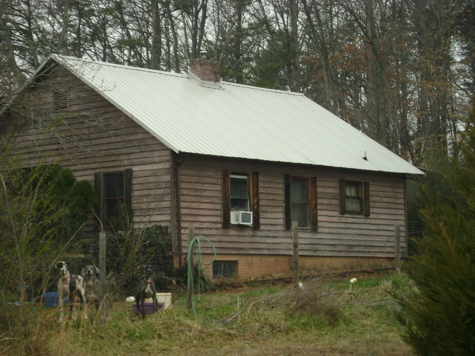 White metal roof on an old wood sided farmhouse, from a Metal Roof Installation job in Phoenicia